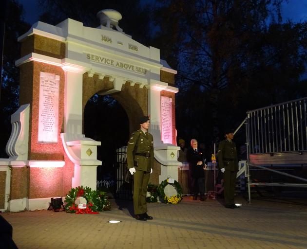 A soldier stands at the memorial gates at the Queenstown Anzac Day dawn service yesterday morning...