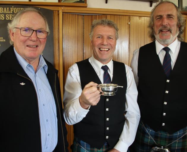 Balfour RSA president Murray McKeown (left) celebrates with Hokonui Celtic Pipe Band member Paul...