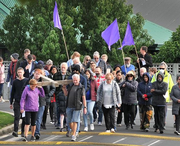 Parishioners from across Taieri participate in the Walk of the Cross in Mosgiel yesterday. PHOTO:...