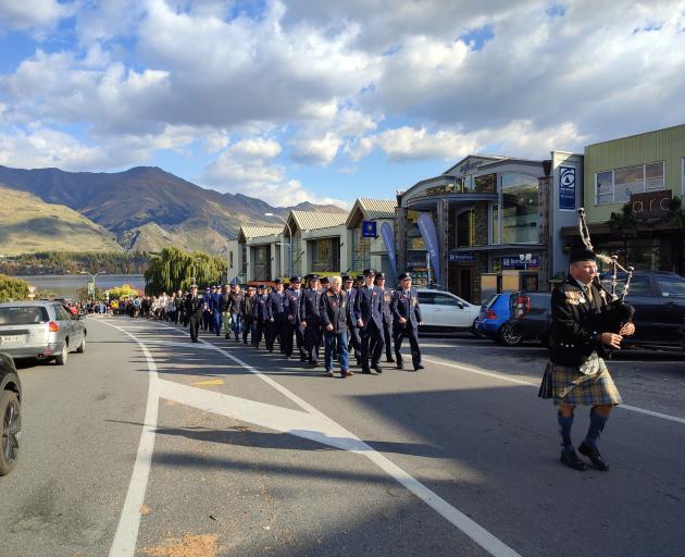 Bagpiper Clifford Hiscock leads the Wanaka Anzac Day parade up Ardmore St. PHOTO: REGAN HARRIS
