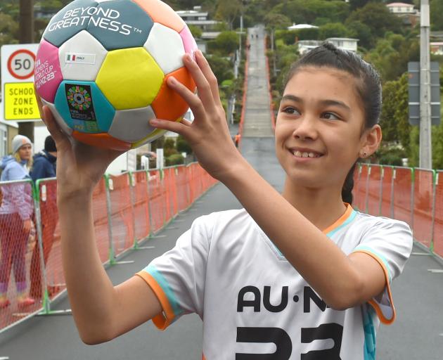 Izabella Christofoletti (12) holds the ball for Italy, which won the race down Baldwin St.