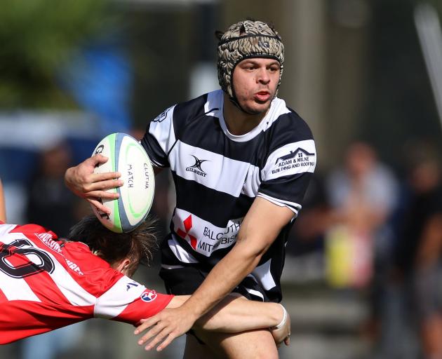 Crescent second five Ethan Edwards tries to escape the clutches of Clutha first five Samuel...