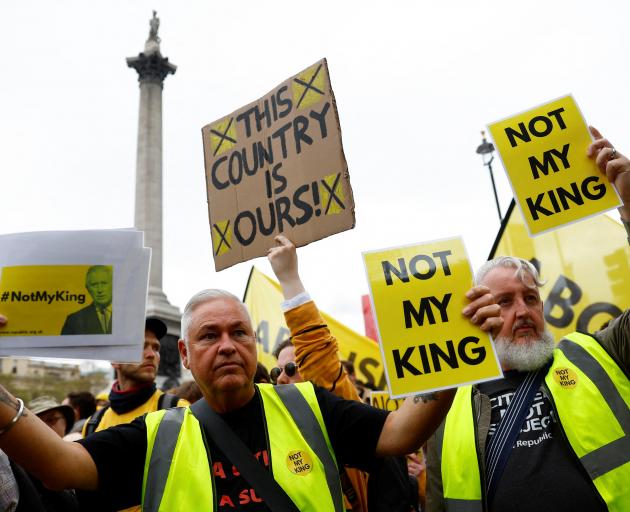 Anti-monarchy demonstrators at The Mall in London hold placards ahead of King Charles’ procession...