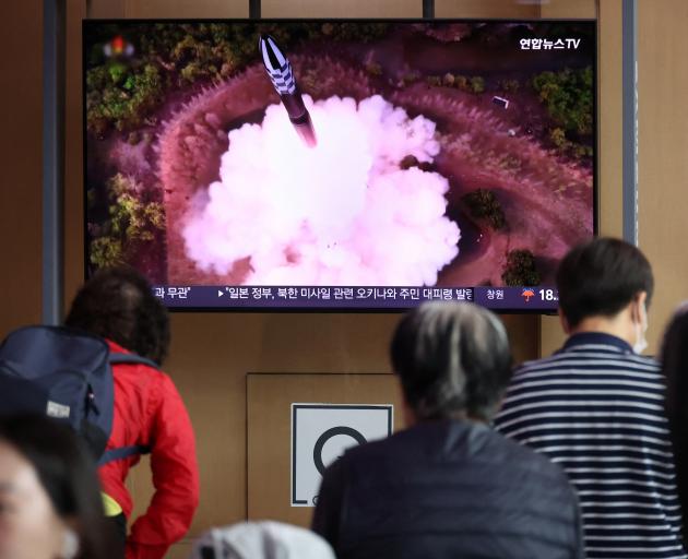 In Seoul, people watched North Korea firing what it called a space satellite toward the south on...