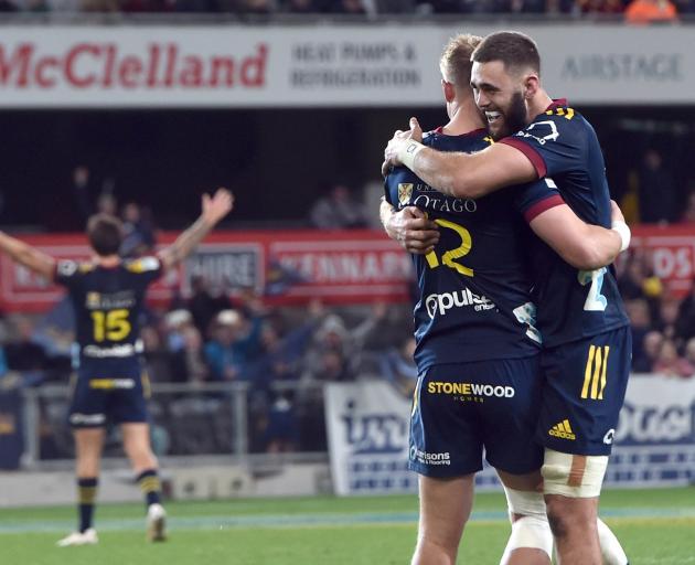 Highlanders goal-kicking hero Sam Gilbert is embraced by team-mate Max Hicks while Connor Garden...