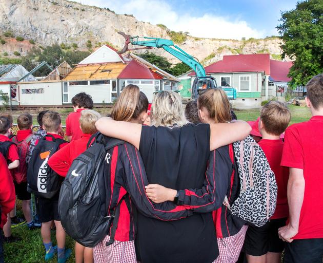 Rose McInerney, centre, embracing year 8 pupils when Redcliffs School's former library was...