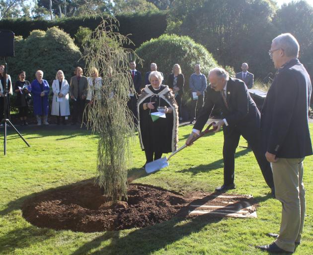 Planting a rimu tree to mark the coronation are (from left) Mana whenua representative Evelyn...