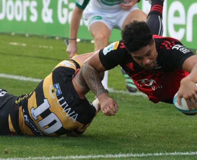 Crusaders winger Leicester Fainga'anuku dives over to score against the Force. Photo / photosport.nz