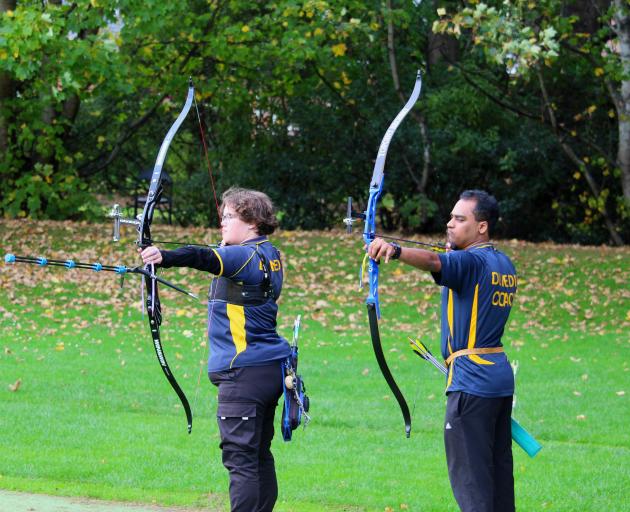 Archers Charlle Harbrow (left) and Tahir Singh practise at the Dunedin Archery Club in Chingford...