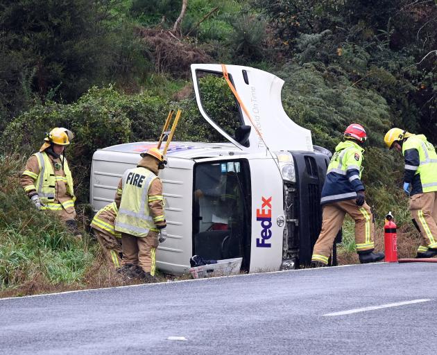 A FedEx van lays on its side in Morris Rd yesterday. PHOTO: CRAIG BAXTER