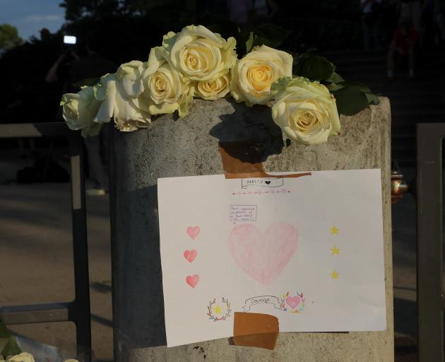 Flowers and a message have been left at the Le Paquier park where four children and two adults...