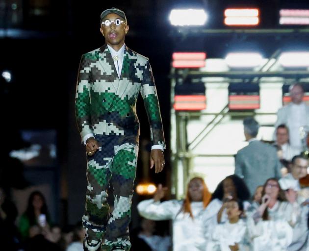 Designer Pharrell Williams appears at the end of his first show for French fashion house Louis...