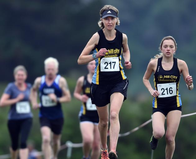 Hill City-University runners Georgina Pakeho (left) and Carly Smith compete in the Barnes Cross...