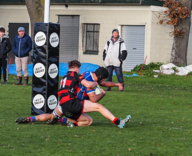 Lock Caleb Aperahama slides over the tryline as Christchurch winger Arden Ongley tries to stop...