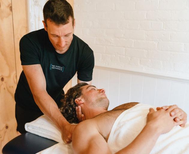Matthew Wallis, from The Muscle Mechanics, works on a client. PHOTO: SOPHIA GAMPERLE / NOURISHED...