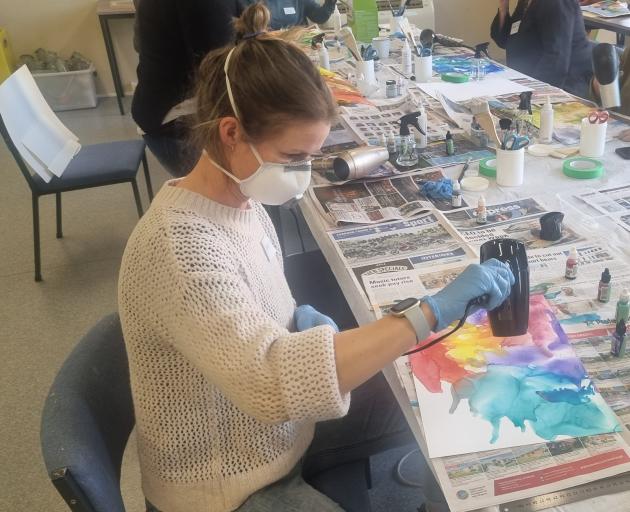 Helen Stewart is all concentration in the Creative Collage Landscapes workshop. PHOTO: BEN TOMSETT