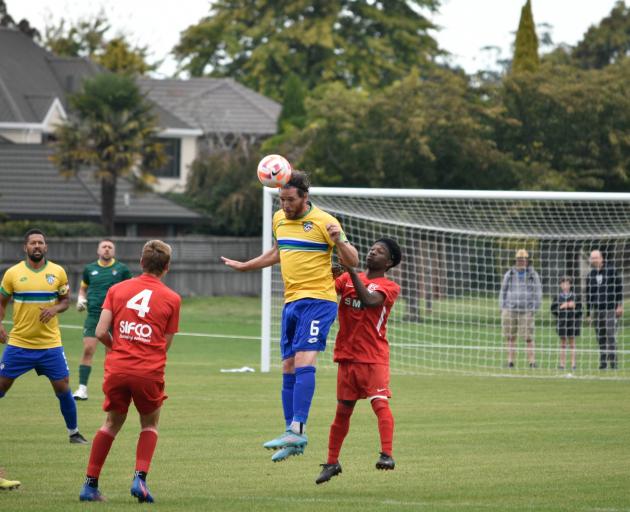 Tom Schwarz gets up for a header against FC Twenty 11 in the Southern League earlier this year....