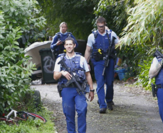 Armed police leaving the Kamo Rd property. Photo: NZ Herald