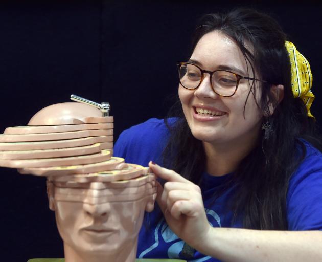 University of Otago PhD student Courteney Westlake examines a section of a brain model during the...