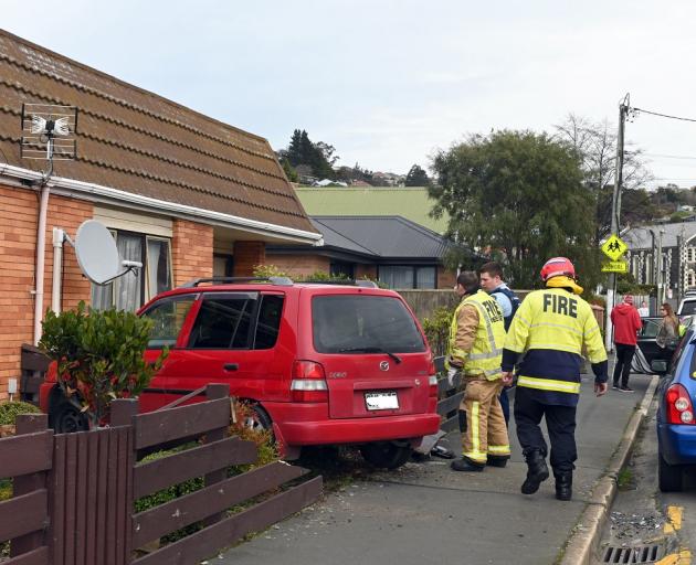 A two-vehicle crash ended ended with one crashing through a fence in Thorn St. PHOTO: LINDA...