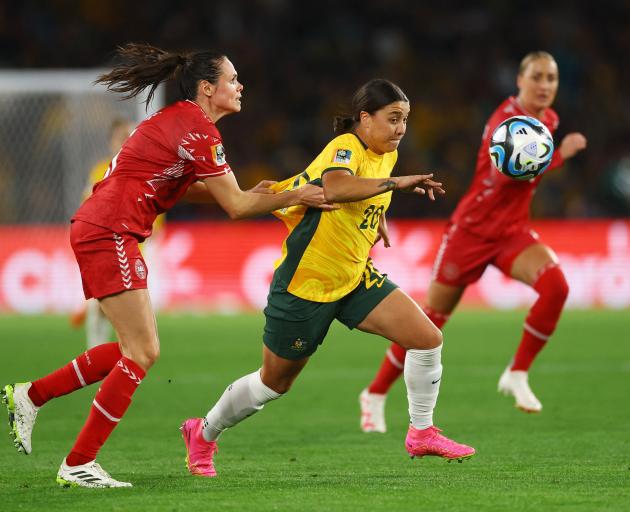 Australia's Sam Kerr is held back by Denmark's Simone Boye Sorensen. Photo: Reuters