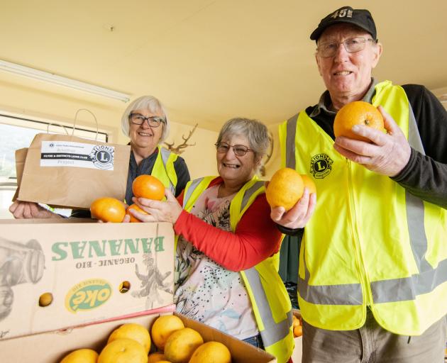 Packing citrus fruit to give away are Clyde and District Lions Club members (from left) Barbara...