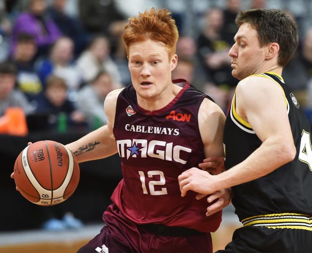 Mitchell Hughan (Mid City Magic) tries to drive past St Kilda Saints defender James Ross during...