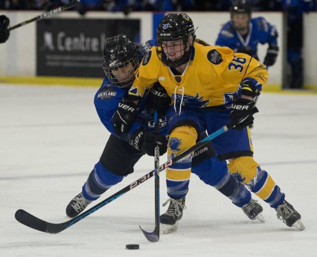 Wakatipu Wild forward Polly Bennetts is put under pressure from Auckland defenceman Jamieson...