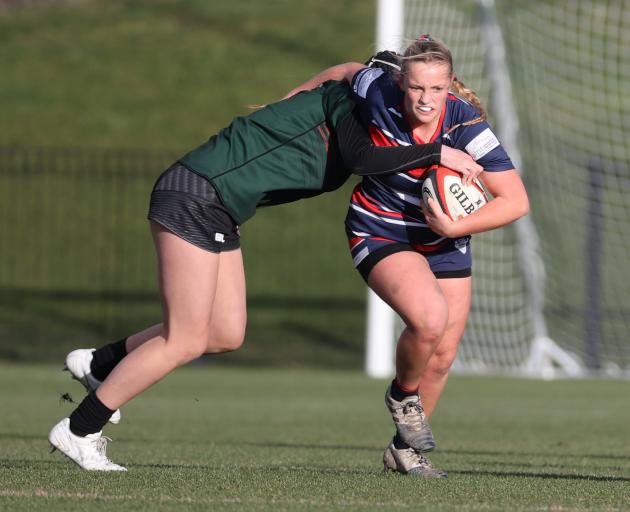 CGHS second-five Sophie Yarham attempts to break away from a tackle in the Miles Toyota Cup final...