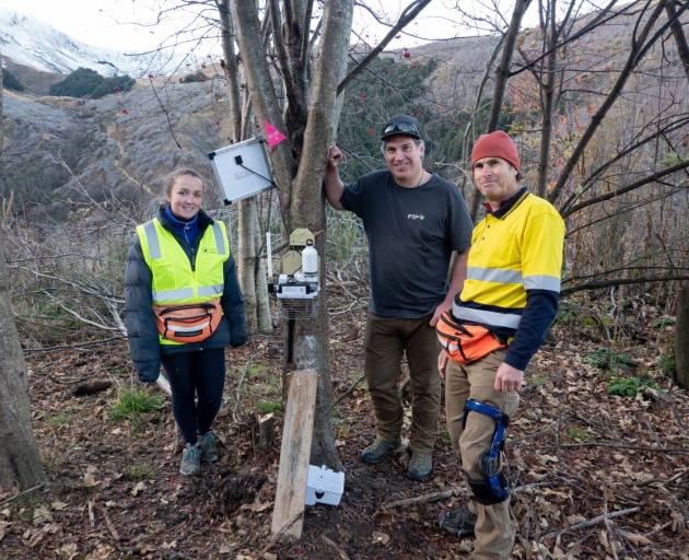 Standing beside a new AT 220 trap in the southern bush are (from left): Southern Lakes Sanctuary...