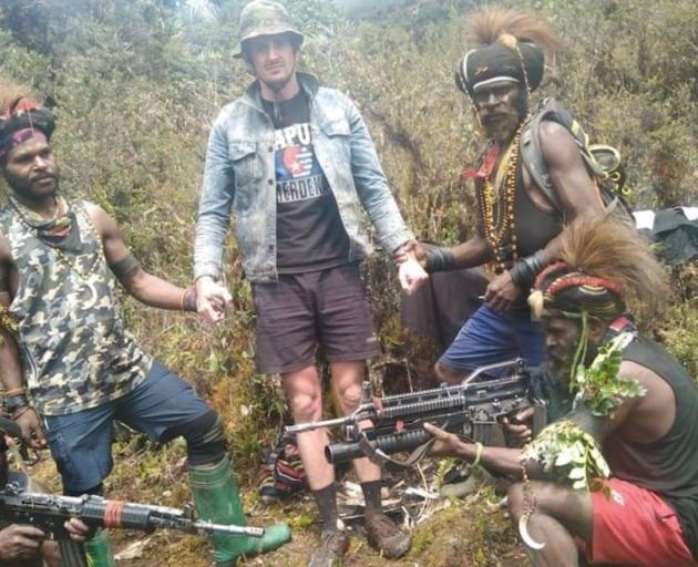 Kiwi pilot Philip Merhtens and his West Papuan captors. Photo: supplied 