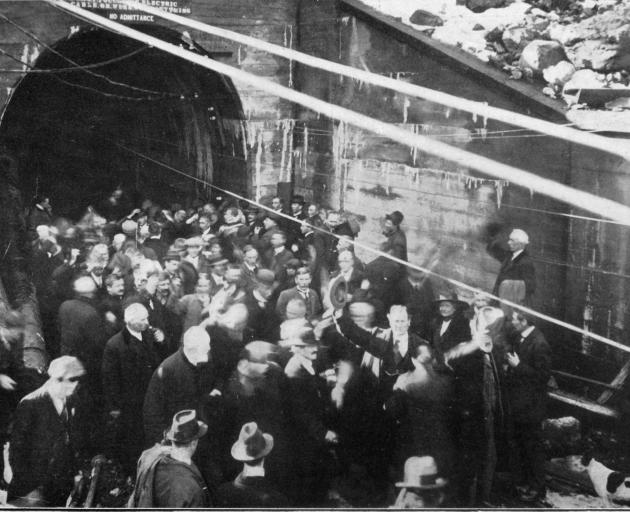 A cheering crowd at the entrance to the Otira Tunnel after the last charge was set off in 1918....