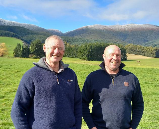 West Otago farm owner Neil Thomson (left) and contract milker Khan Ward discuss their farming...