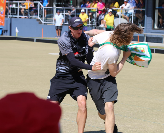 Andrew Kelly tackles the man fleeing from police during the World Bowls Championships on the Gold...
