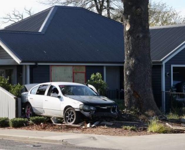 The car crashed into a tree and then a house on McIvor Place in Rangiora. Photo: George Heard