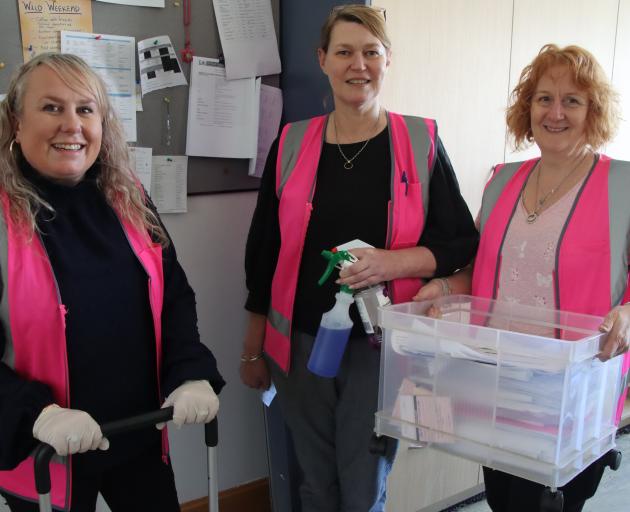 Cleaning up the office area at St Peter’s College after surface water entered the buildings last...