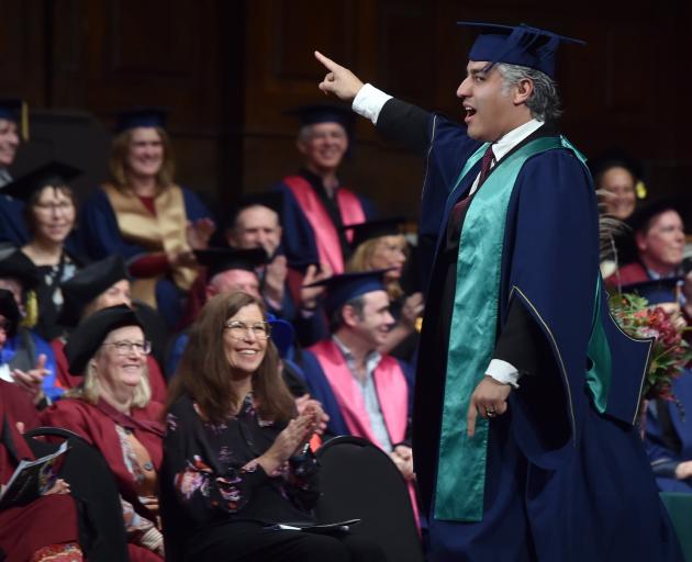 Derek Piva celebrates while walking across the Dunedin Town Hall stage after collecting his...