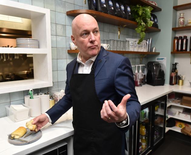 National Party leader Christopher Luxon tries a Southland delicacy at the Majestic Cafe in...