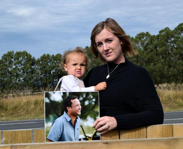 Georgia Redshaw holds a picture of her late fiance Joseph "Moss" Cross and their daughter Breeana...