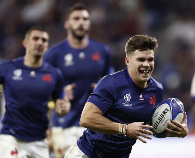 Matthieu Jalibert on his way to scoring France's fifth try against Italy in Lyon. Photo: Reuters 