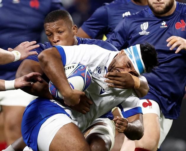 France's Cameron Woki wraps up Italy's Hame Faiva in a tackle.  Photo: Reuters 