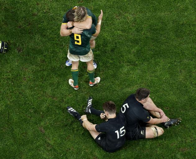 South Africa's Faf de Klerk celebrates after winning the World Cup final as All Black brothers...