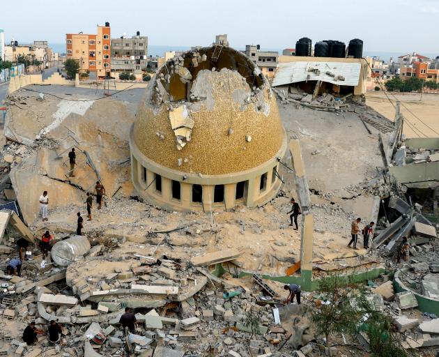 Palestinians inspect a mosque destroyed in Israeli strikes in Khan Younis. PHOTO: REUTERS