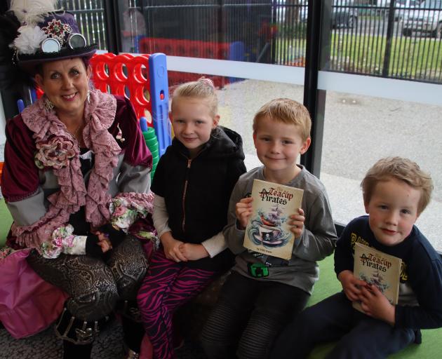Tapanui author Vicki Yarker-Jones, aka Vicki Purple, gives a copy of her book The Teacup Pirates...