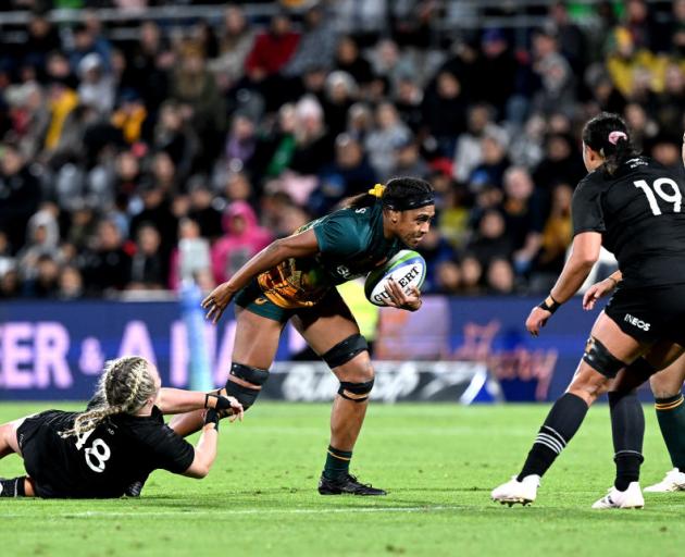 Wallaroos lock Sera Naiqama’s progress is hampered by Black Ferns prop Amy Rule during the...