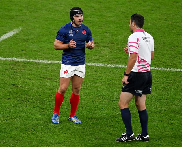 Antoine Dupont speaks with New Zealand referee Ben O’Keeffe during the quarterfinal against South...
