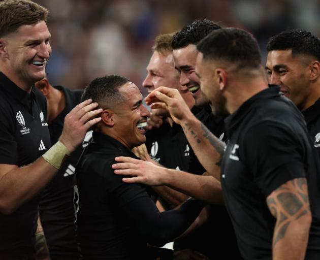 All Black halfback Aaron Smith (centre) celebrates with his team-mates after scoring a try in his...