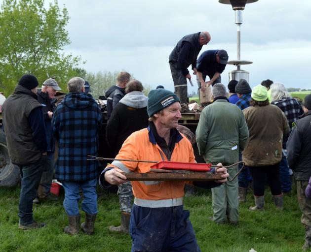 Winning an auction at the clearing sale is Tordon McIntyre, of Myross Bush. PHOTO: SHAWN MCAVINUE