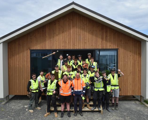 Otago Polytechnic Te Pūkenga students and lecturers celebrate completing the annual charity house...
