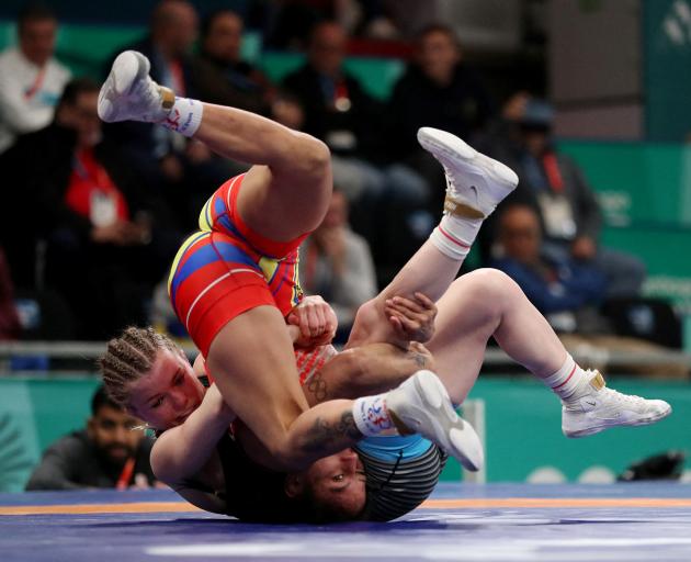 Luisa Valverde, of Ecuador, and Hannah Taylor, of Canada, compete in the women’s freestyle 57kg...